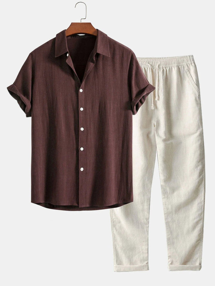 Comfortable men's two-piece outfit with rolled cuff shirt & matching pants, ideal for vacation.
