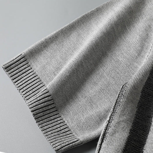 Model wearing a charcoal wood grain textured knit tee for men. Modern, casual, and soft comfort wear.