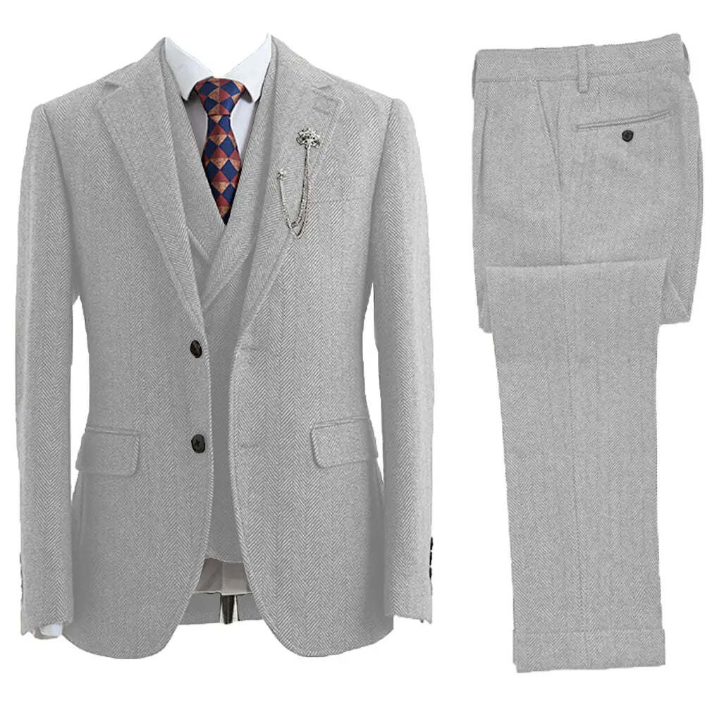 Stylish man wearing a classic tailored 3-piece herringbone suit, perfect for formal events.