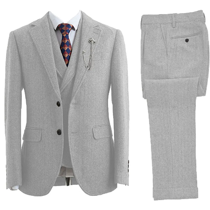 Stylish man wearing a classic tailored 3-piece herringbone suit, perfect for formal events.