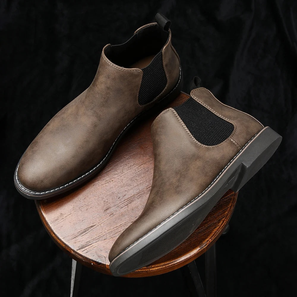 Comfortable men's Chelsea boots, engineered for all-day wear with cushioned sole. Durable & versatile footwear.