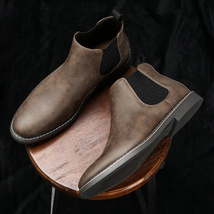Comfortable men's Chelsea boots, engineered for all-day wear with cushioned sole. Durable & versatile footwear.