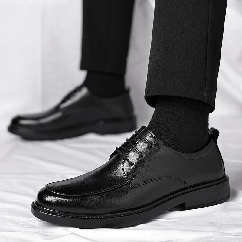 Close-up of men's classic lace-up oxford dress shoes, showcasing fine leather and timeless design.