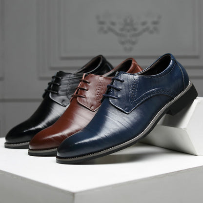 Top-down view of men's sleek black Oxford dress shoes, classic formal footwear for men.