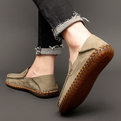 Elegant black leather slip-on loafers for men, ideal dress shoes for occasions.