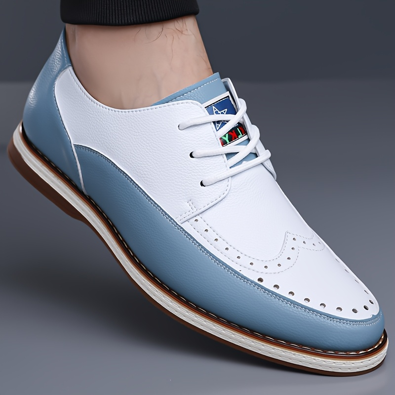Men's premium blue leather brogue shoes with intricate details & cushioned comfort for refined formal wear.