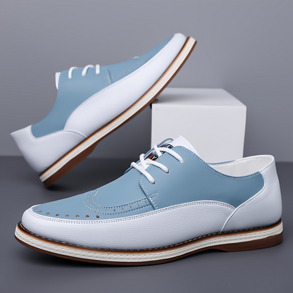 Front view of elegant men's blue brogue dress shoes, ideal for formal occasions, offering superior comfort.