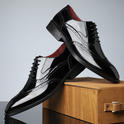 Detailed close-up of men's classic brogue wingtip dress shoes, showcasing polished leather & craftsmanship.
