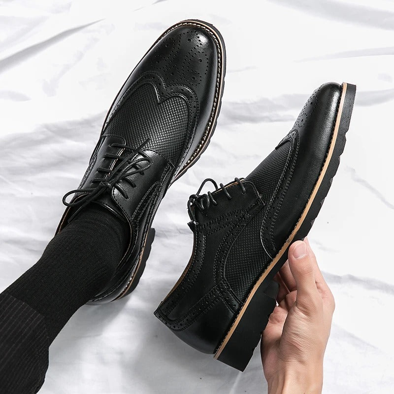 Stylish men's black leather brogues, classic design, ideal for formal occasions and professional business wear.