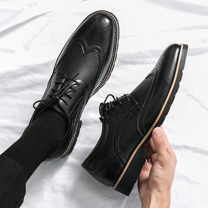 Stylish men's black leather brogues, classic design, ideal for formal occasions and professional business wear.