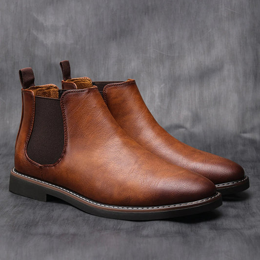 Men's classic brown leather Chelsea boots, showcasing smooth texture and elastic side panels.