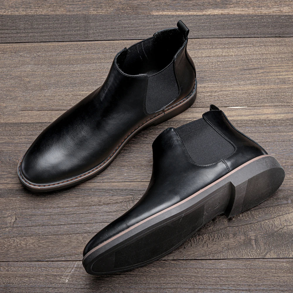 Men's formal Chelsea boots with tailored trousers, ready for a business casual event.