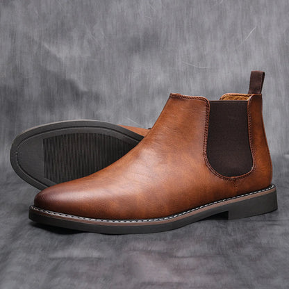 Stylish men's black leather Chelsea boots, perfect for casual outfits, worn with dark jeans.