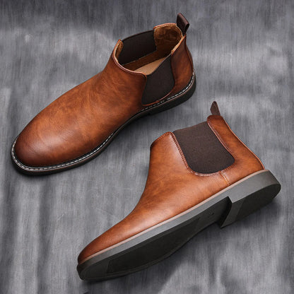 Side view of a comfortable men's ankle Chelsea boot, highlighting its timeless design.