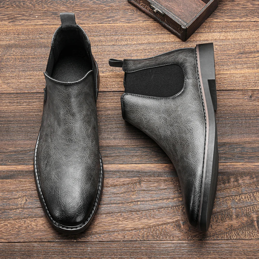 Back view of men's sleek Chelsea boots with a convenient pull tab for easy on/off.
