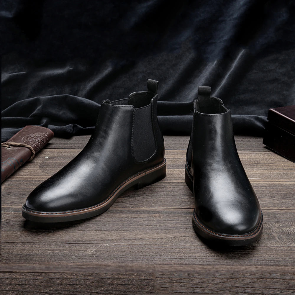 Men's stylish Chelsea boots paired with denim jeans, showcasing a perfect casual look.