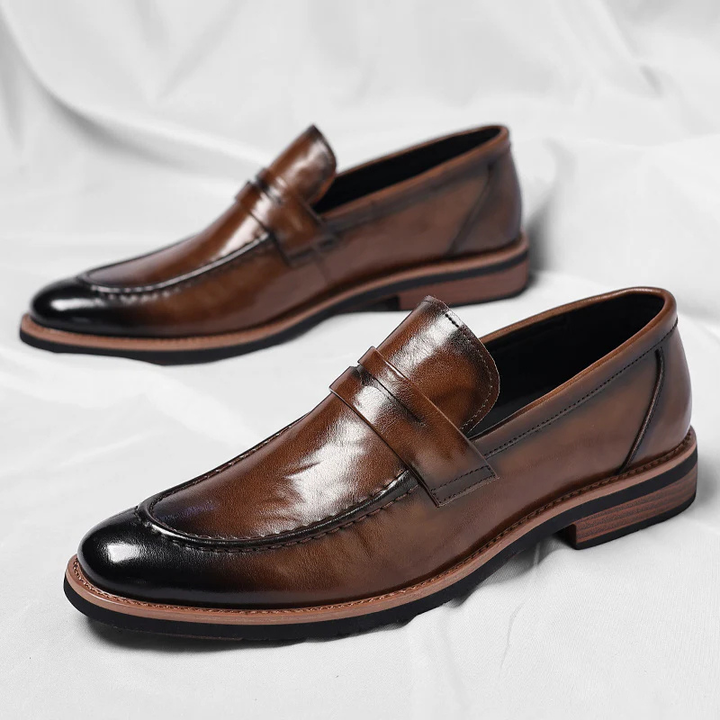Side view of stylish men's black leather penny loafers, classic comfortable slip-on footwear for all-day wear.