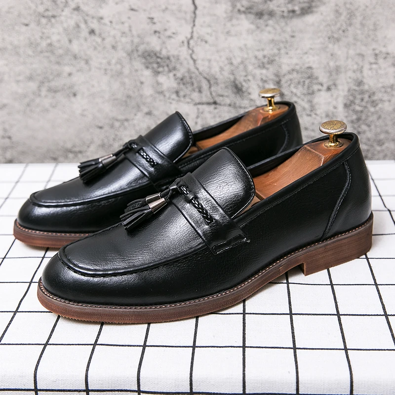 Timeless brown men's slip-on tassel loafers, essential formal and casual footwear.