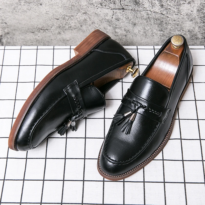 Polished black men's dress shoes: elegant tassel loafers for a sharp, professional look.
