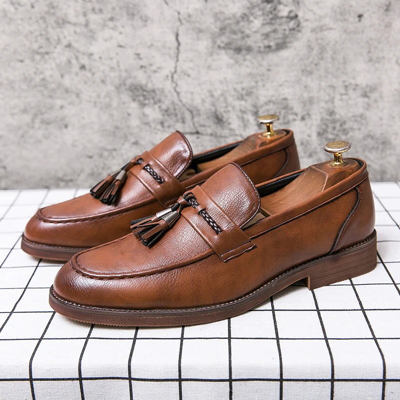 Black slip-on tassel loafers for men, offering timeless style & comfort in dress footwear.