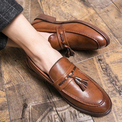 Polished black tassel loafers for men, a versatile classic style dress shoe.