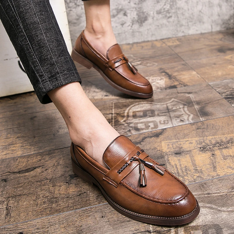 Men's formal black leather tassel loafers, combining comfort with timeless style.