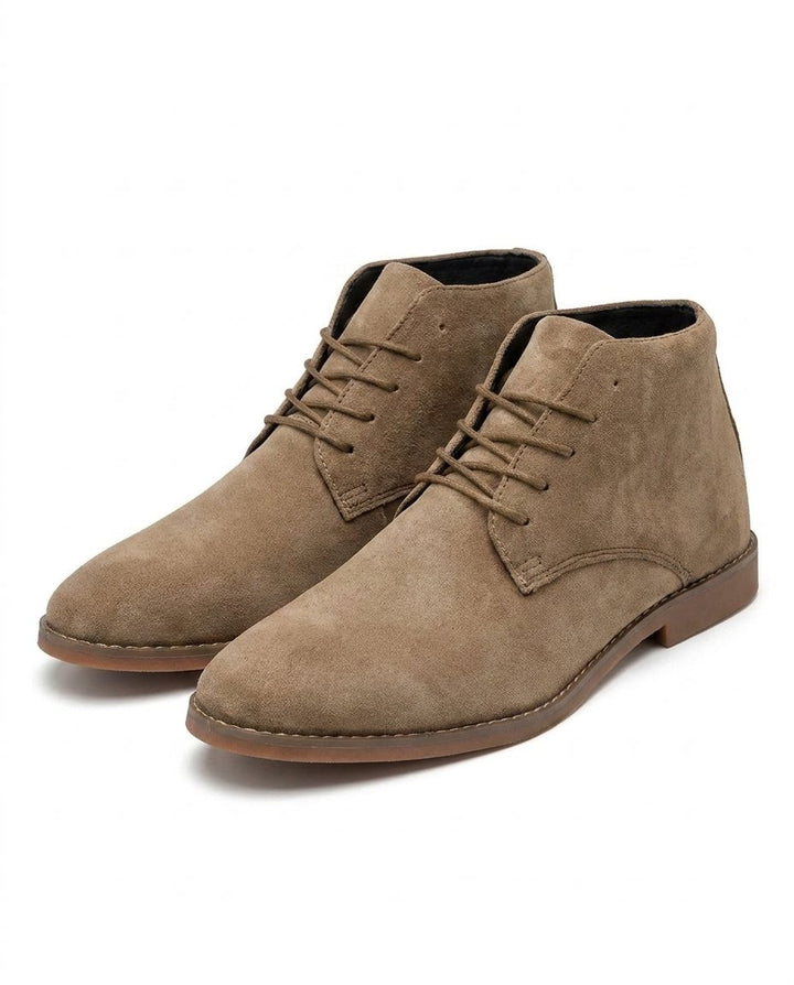 Men's durable suede ankle boots with laces, shown outdoors, offering comfort and rugged style for versatile adventures.