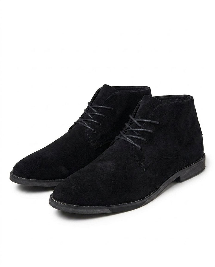 Close-up of men's classic suede ankle boot, highlighting durable stitching and comfortable sole for quality footwear.