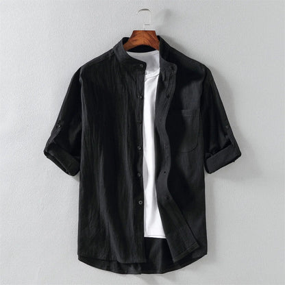 Man wearing a relaxed fit men's cotton button-up shirt, styled for comfortable and breathable everyday wear.