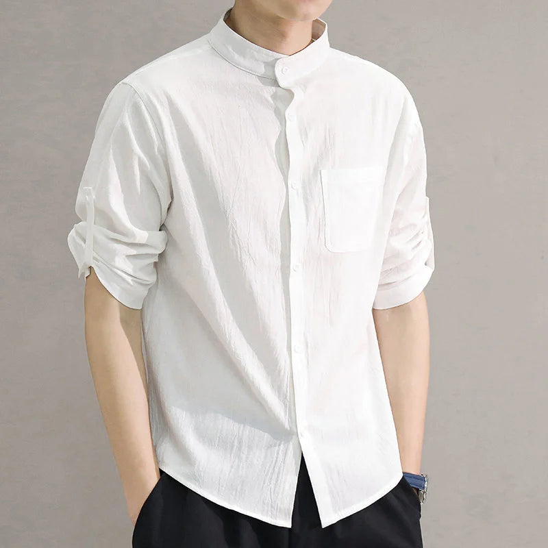 Detail of the buttons and collar on a men's classic long sleeve cotton button-up shirt, designed for comfort.