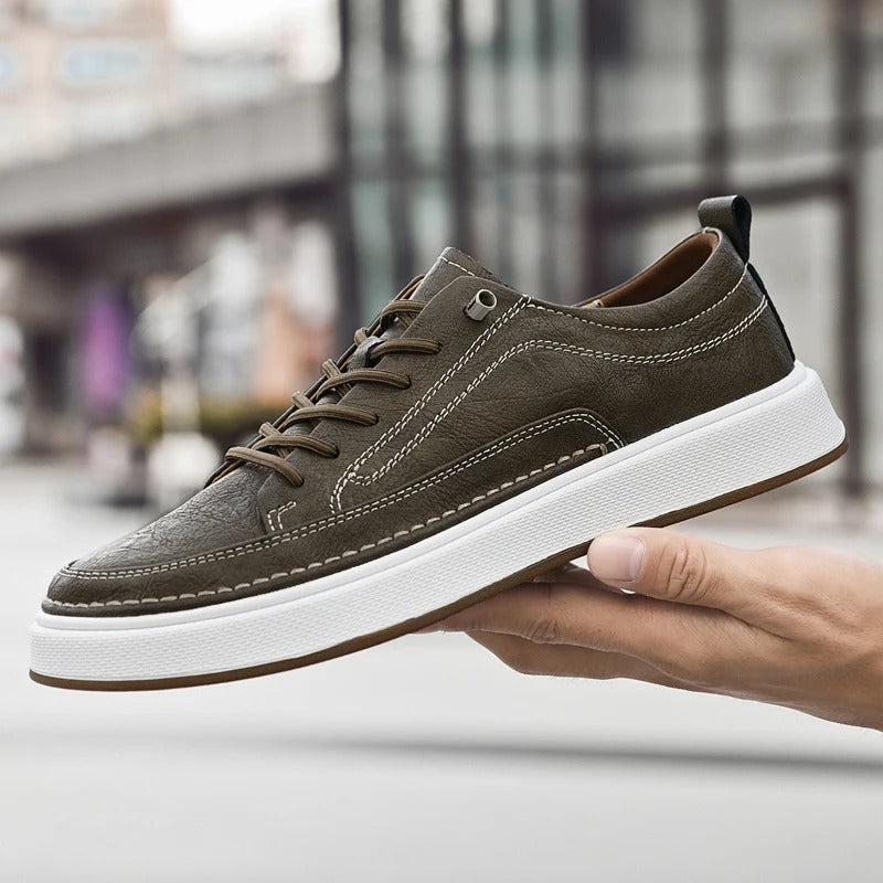 Black cowhide casual footwear for men, stylish and comfortable all-day sneakers.