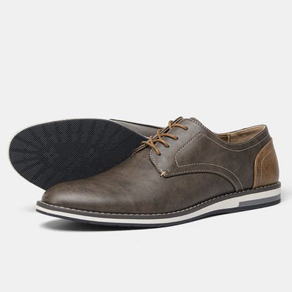 Close-up of polished black leather men's derby shoes, showcasing craftsmanship for formal and professional wear.