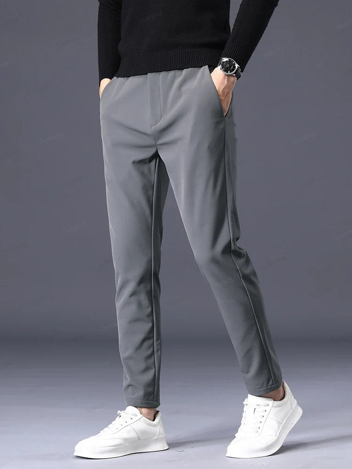 Comfortable gray classic fit dress pants for men, tailored design with elastic waist, versatile for work or leisure.