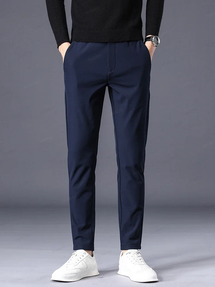 Tailored black men's classic fit dress pants, comfortable elastic waist, perfect for a smart yet relaxed look.