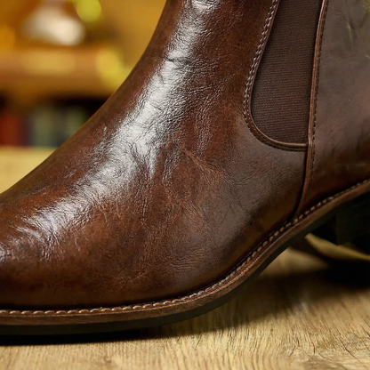 Black full-grain leather men's Chelsea boots, classic slip-on ankle style for modern men's fashion.