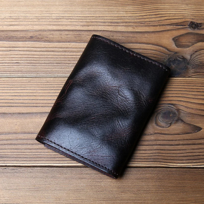 Men's durable full-grain leather trifold wallet, featuring a classic design for secure everyday carry.