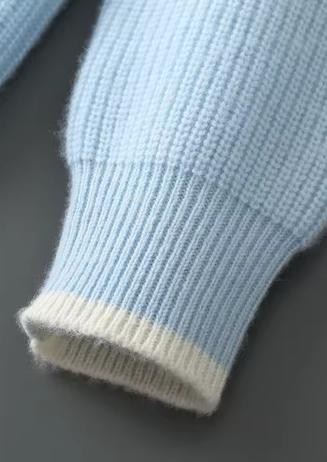 Detailed view of the fine knit pattern on this men's classic crew neck long sleeve sweater.