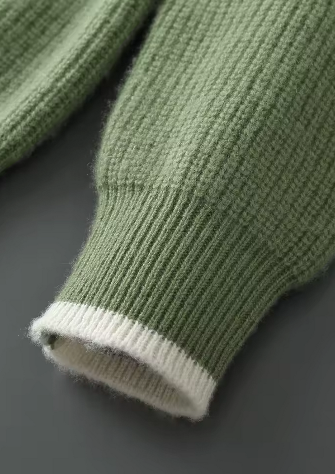 Men's crew neck knitted sweater neatly folded, emphasizing its quality and classic design.