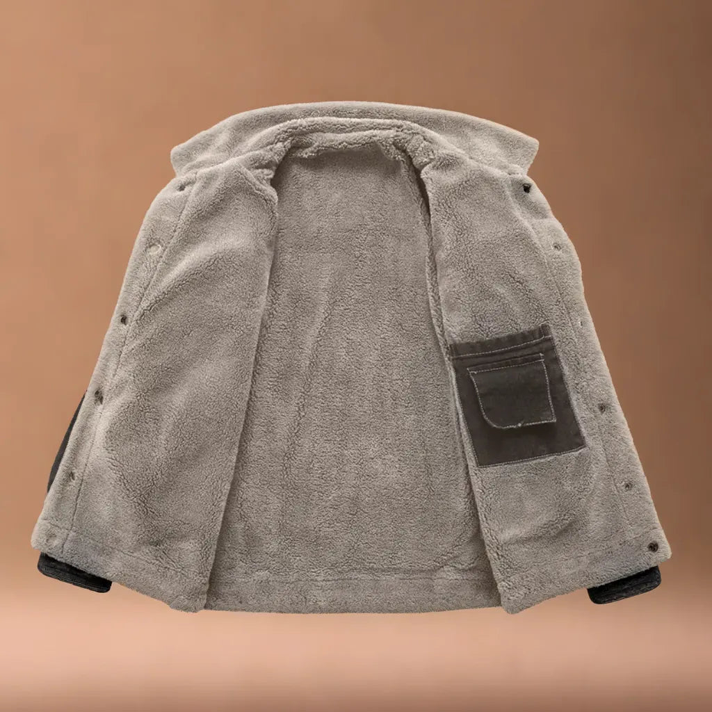 Close-up of a men's insulated trucker jacket fabric, showcasing classic style & durability.