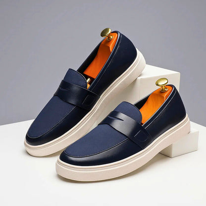Stylish men's navy Italian penny loafers, perfect slip-on shoes for casual or dressy occasions.