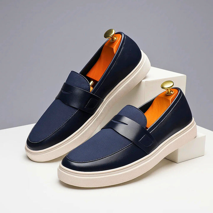 Stylish men's navy Italian penny loafers, perfect slip-on shoes for casual or dressy occasions.