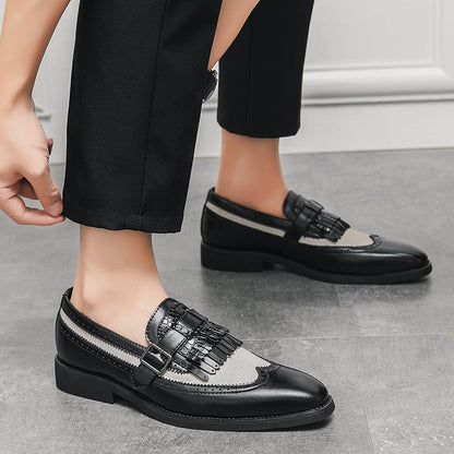 Men's leather dress loafers with brogue patterns and a stylish fringe, for an elevated look.