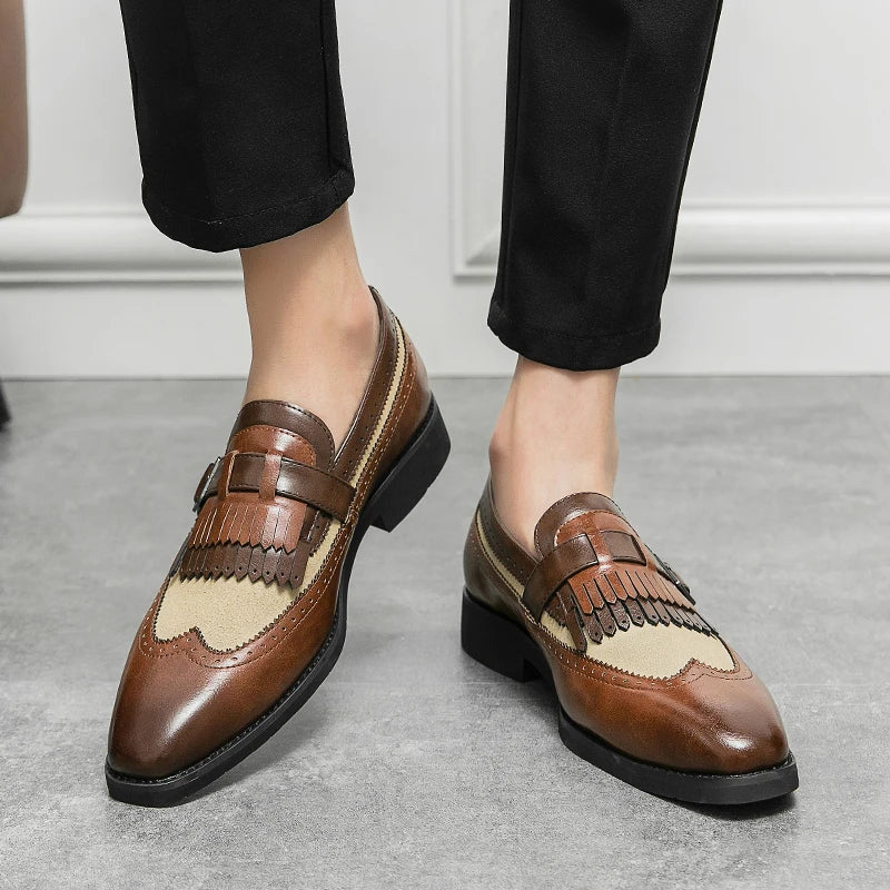 Pair of men's formal brogue loafers featuring a detailed wingtip and fashionable fringe.