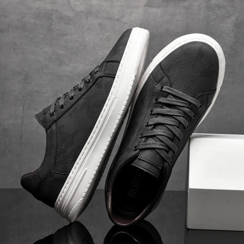 Close-up of black men's classic leather sneakers, showing fine leather texture & comfortable design.