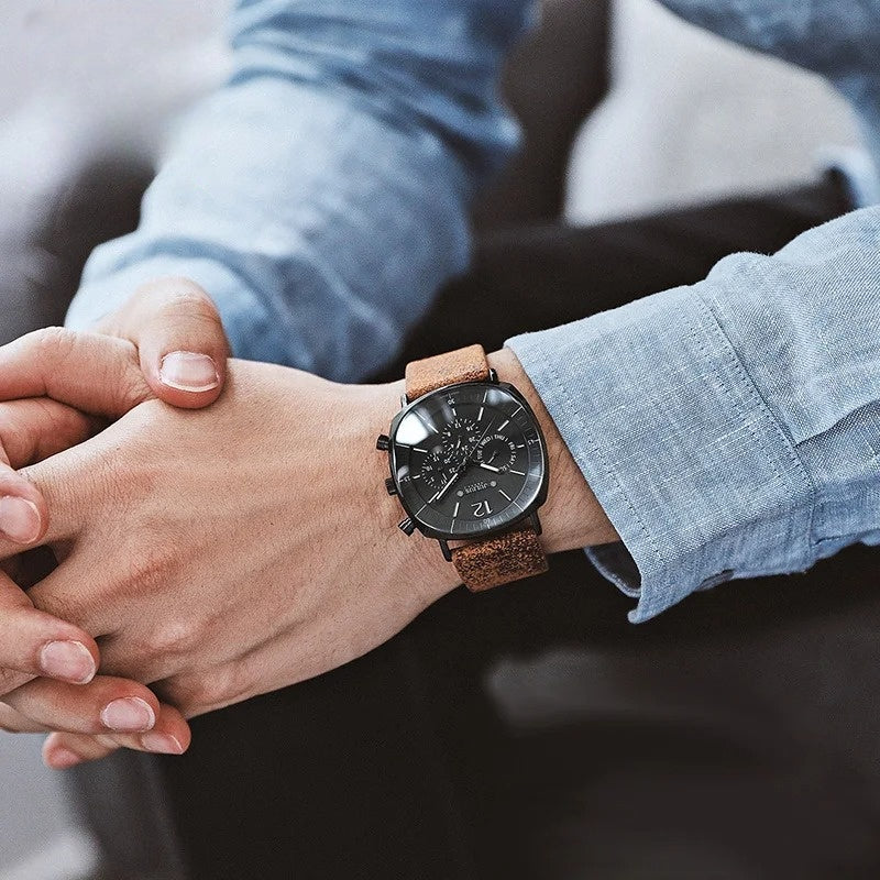 Stylish men's analog watch on a wrist. A classic chronograph with a comfortable leather strap, perfect for formal wear.
