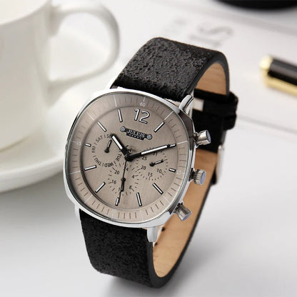 Angled view of a men's precision quartz chronograph watch. Features a sleek design with a black dial and leather band.