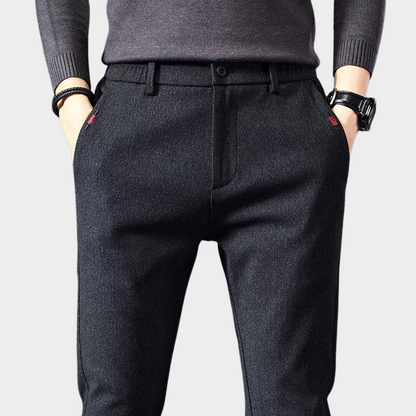 Man in versatile men's classic slim fit pants, pairing them for smart casual look, highlighting comfort & modern style.