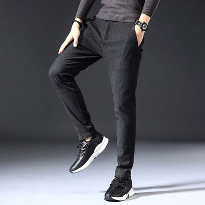 Active man wearing comfortable, wrinkle-resistant men's slim fit pants, demonstrating flexibility for everyday movement.