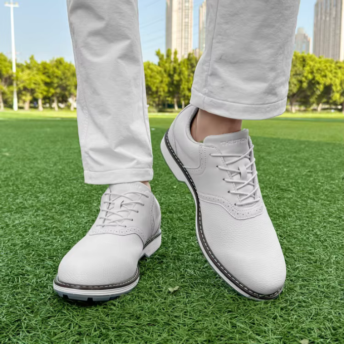 Waterproof men's golf footwear, classic spiked design, built for all-weather durability.