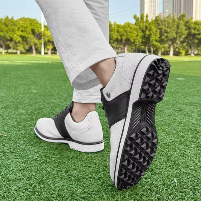 Men's athletic golf shoes, spiked, featuring a waterproof leather upper for all-weather play.